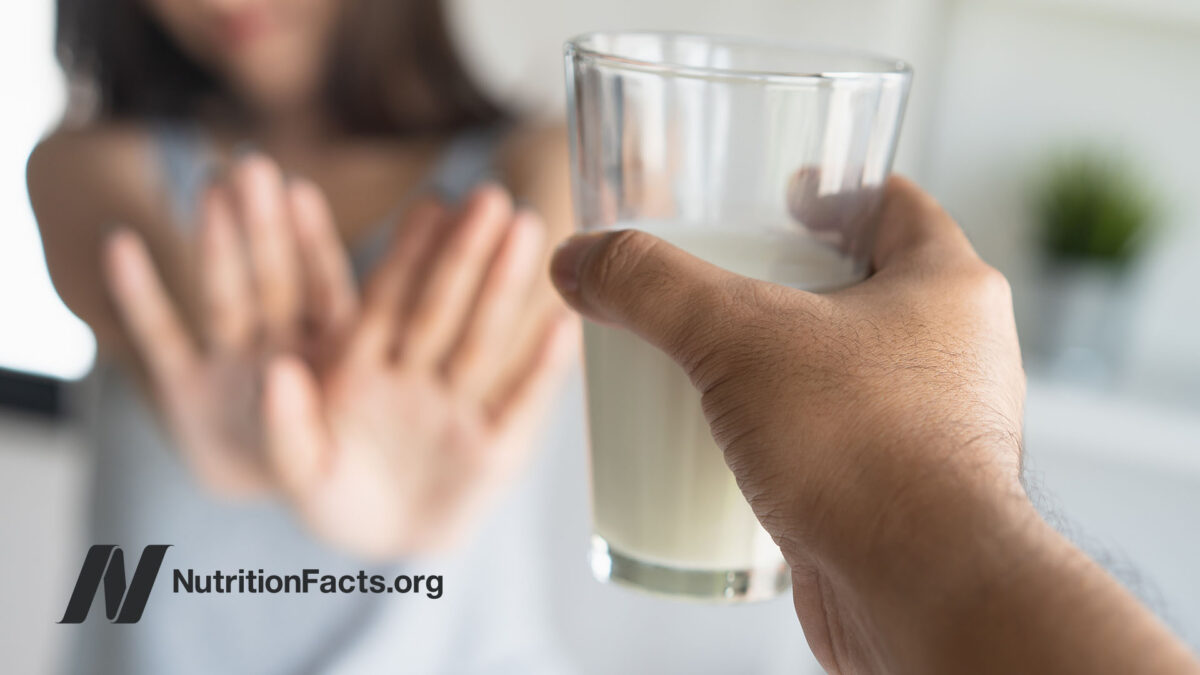 person holding glass of milk