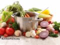 variety of raw veggies around a cooking pot