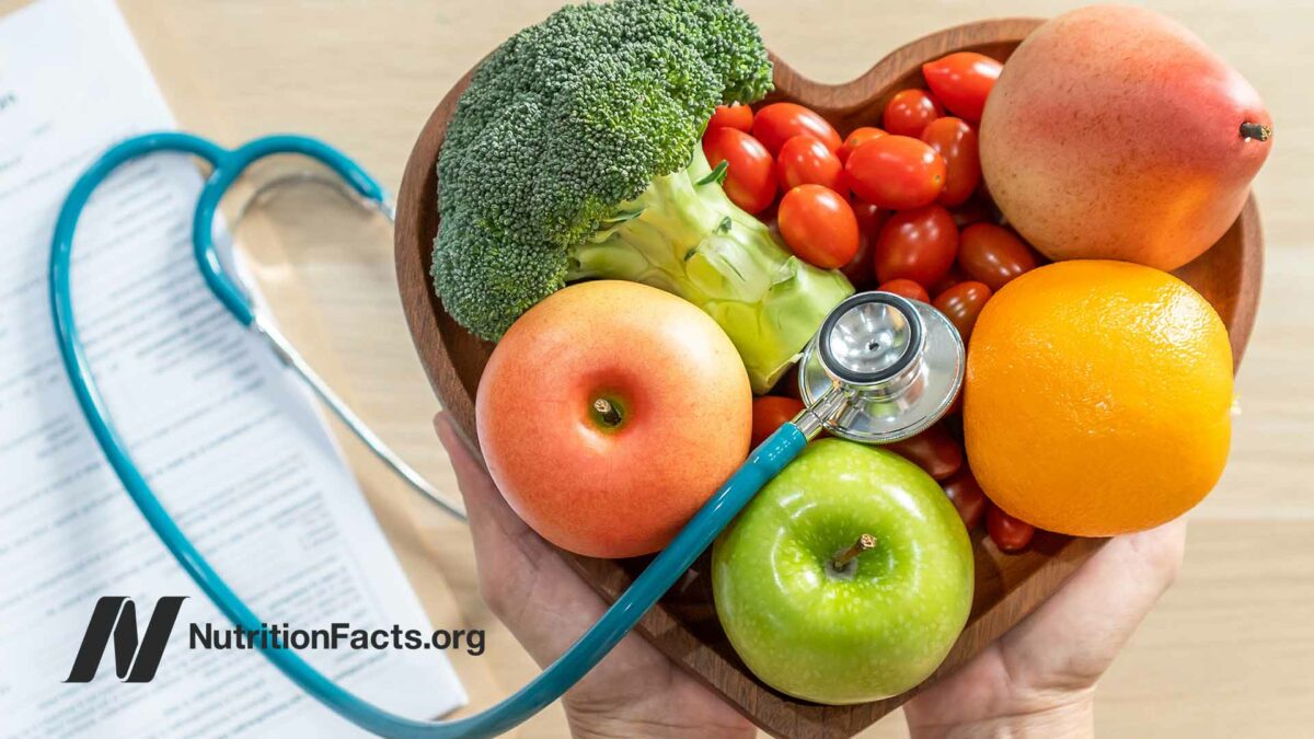 fruits and veggies in heart-shaped bowl with stethoscope
