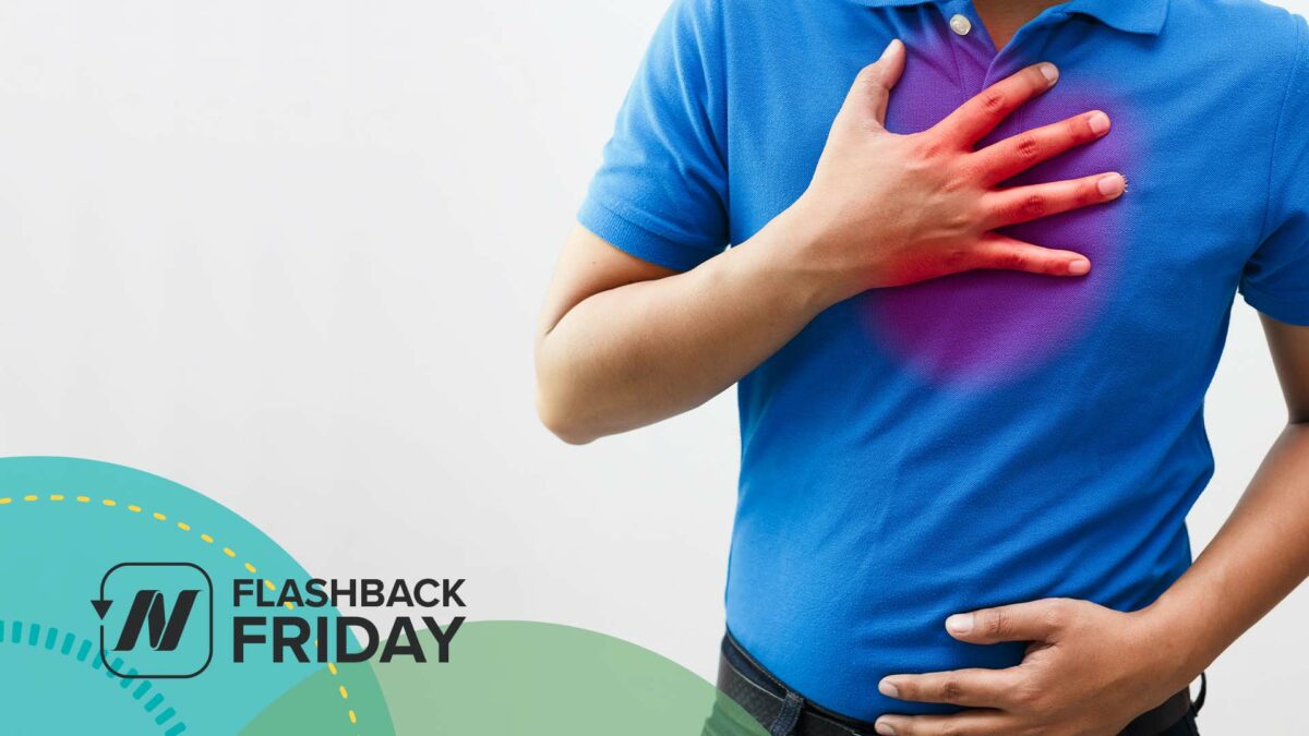 man wearing blue shirt with hand on chest