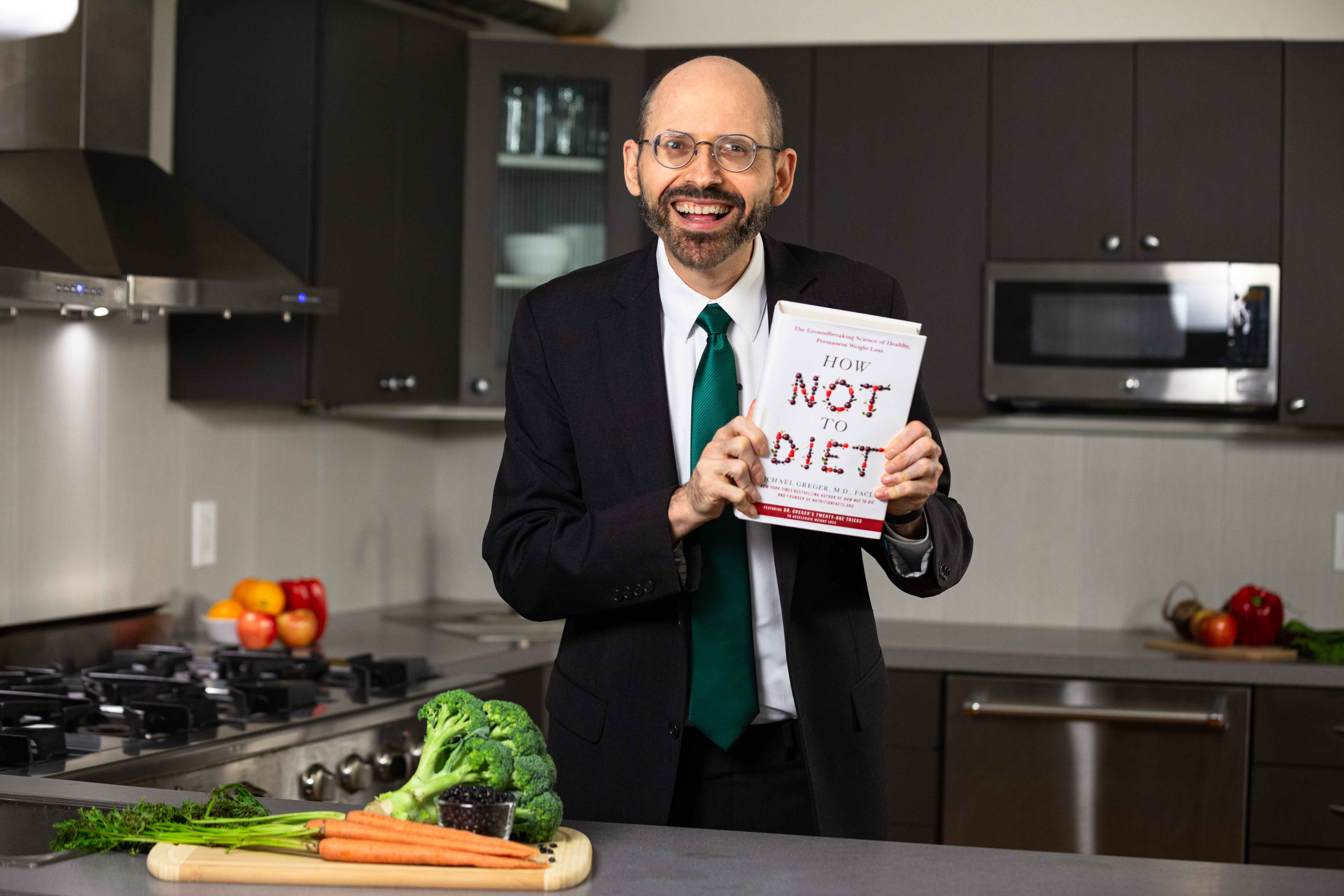 Dr. Greger Holding How Not to Diet