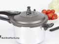 pressure cooker with tomatoes in background