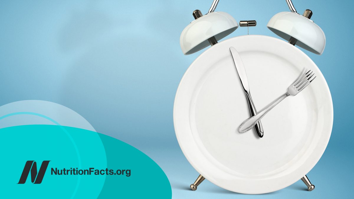 Plate as an Alarm clock with knife and fork as clock hands on blue background