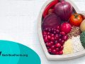 Healthy fruits and vegetables in heart shaped bowl