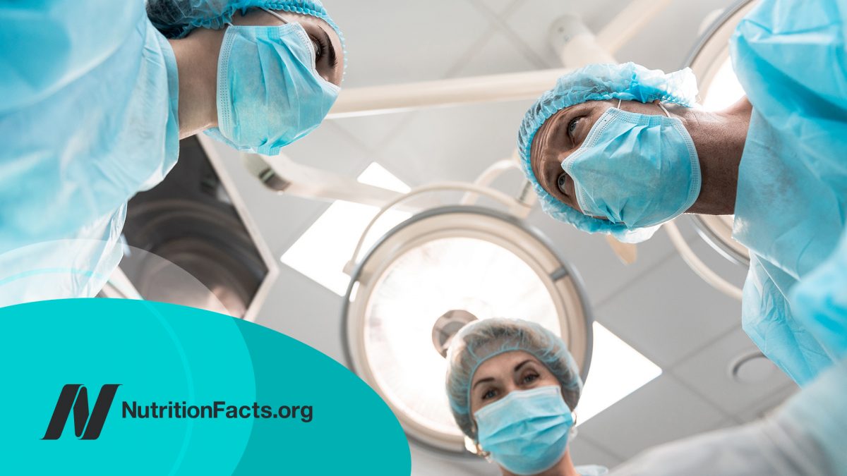 View of the operation room with three doctors in blue medical masks