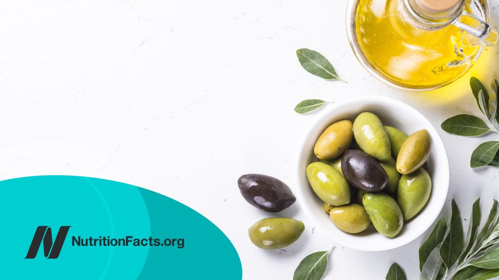 Olives and olive oil on white background