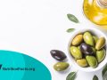 Olives and olive oil on white background