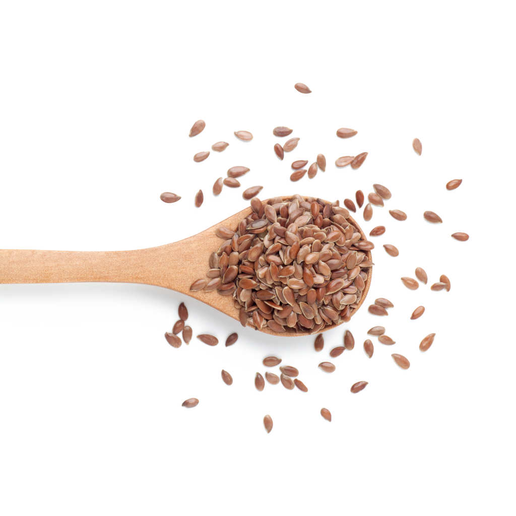 Flax seeds on spoon on light background