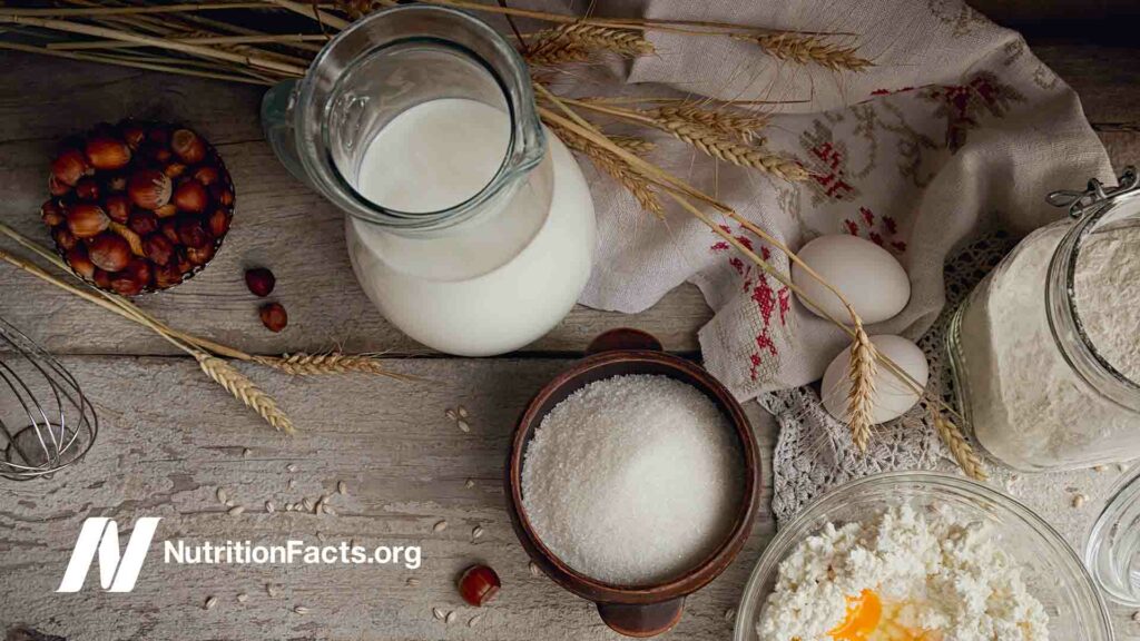 Milk, cottage cheese, sour cream and wheat on rustic wooden background