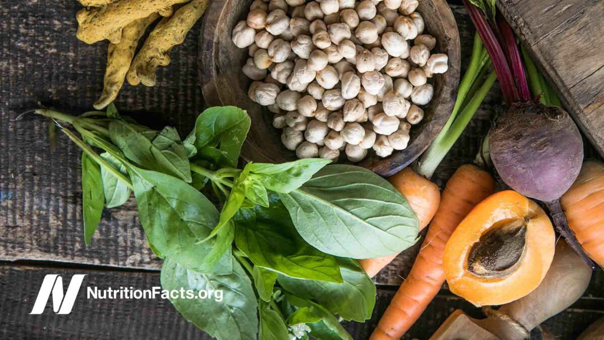 Large collection of the healthy foods including spinach, garbanzo beans, carrots, beets, ginger.