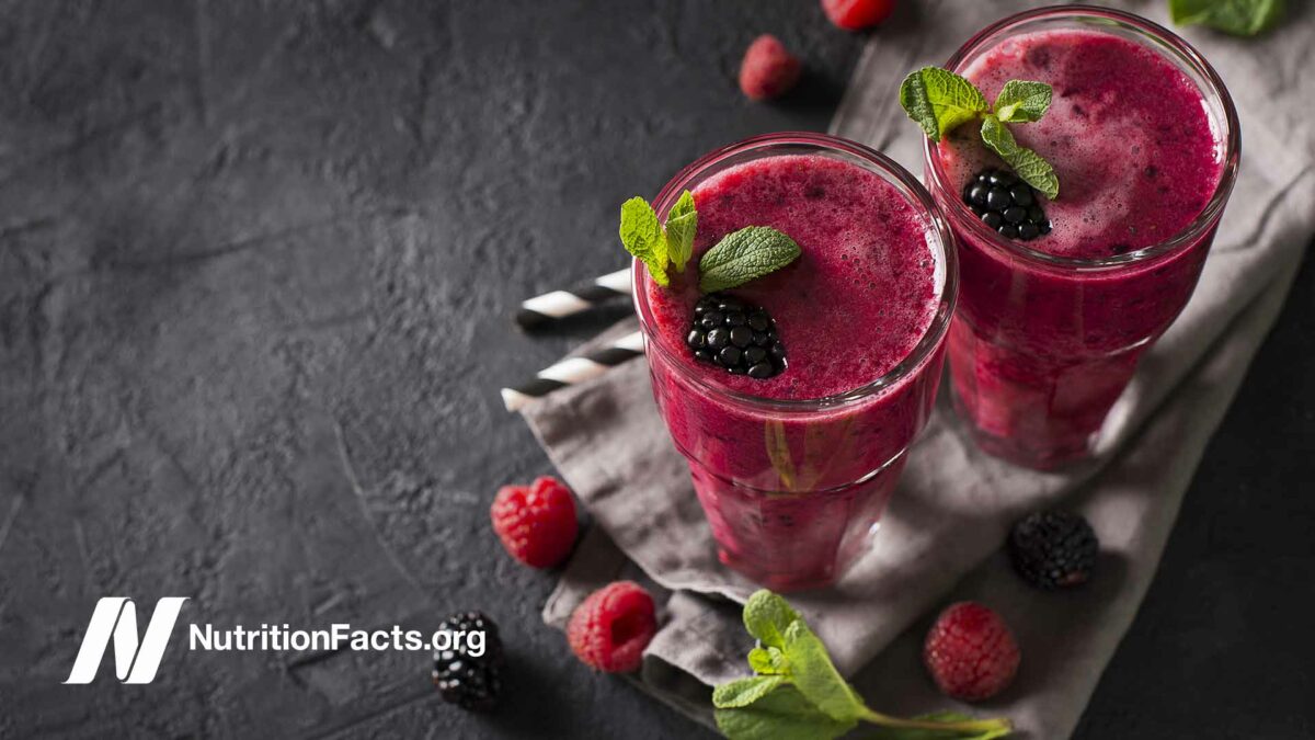 top view of berry smoothies on a dark countertop
