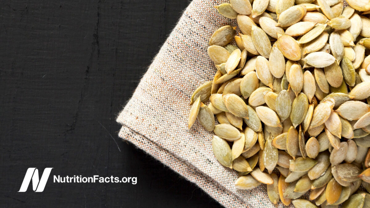 roasted pumpkin seeds on cloth over black surface