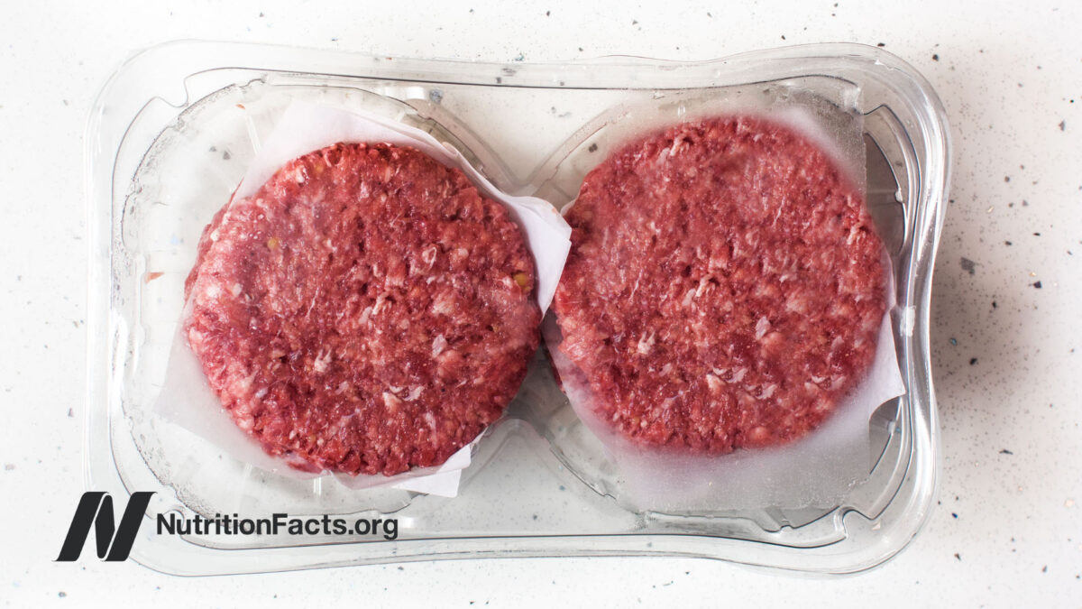 burger meat packaged in plastic on white stone counter