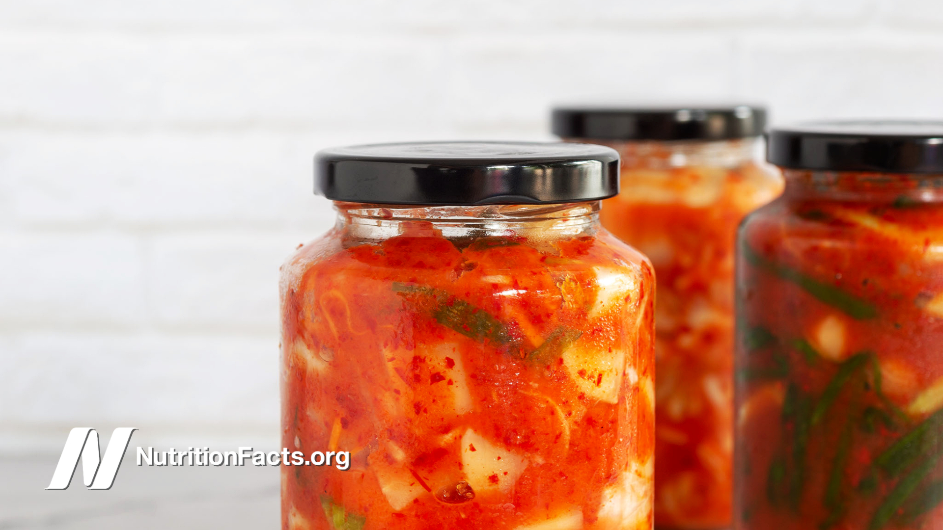homemade kimchi in jars in a bright white kitchen