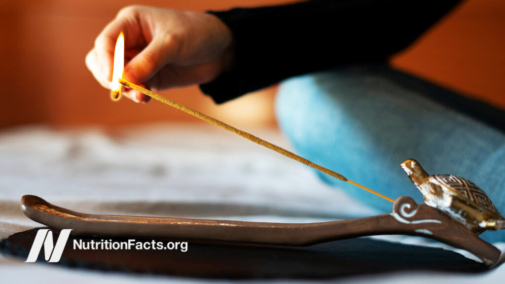 Lighting incense in a holder