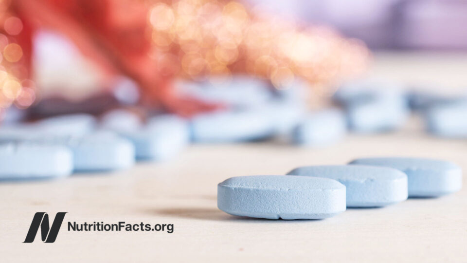 Blue vitamin pills on white surface