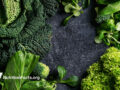 Assorted green cruciferous on a slate surface