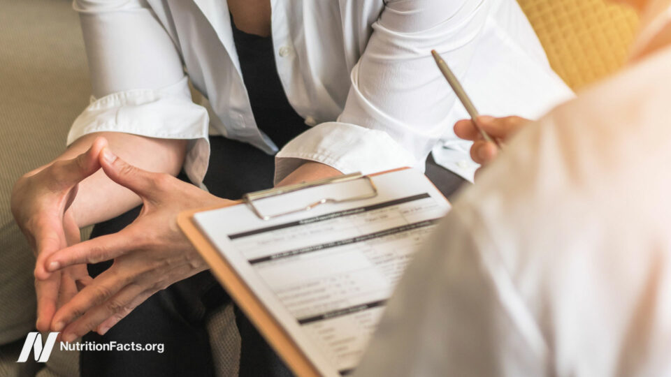 Two people evaluating a medical file