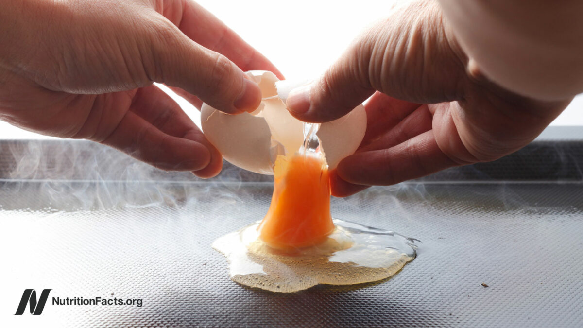 Cracking an egg over a hot griddle