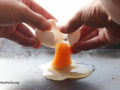 Cracking an egg over a hot griddle
