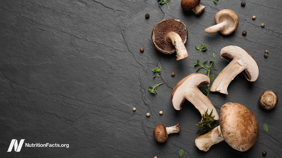 Flat lay composition with fresh wild mushrooms on black table
