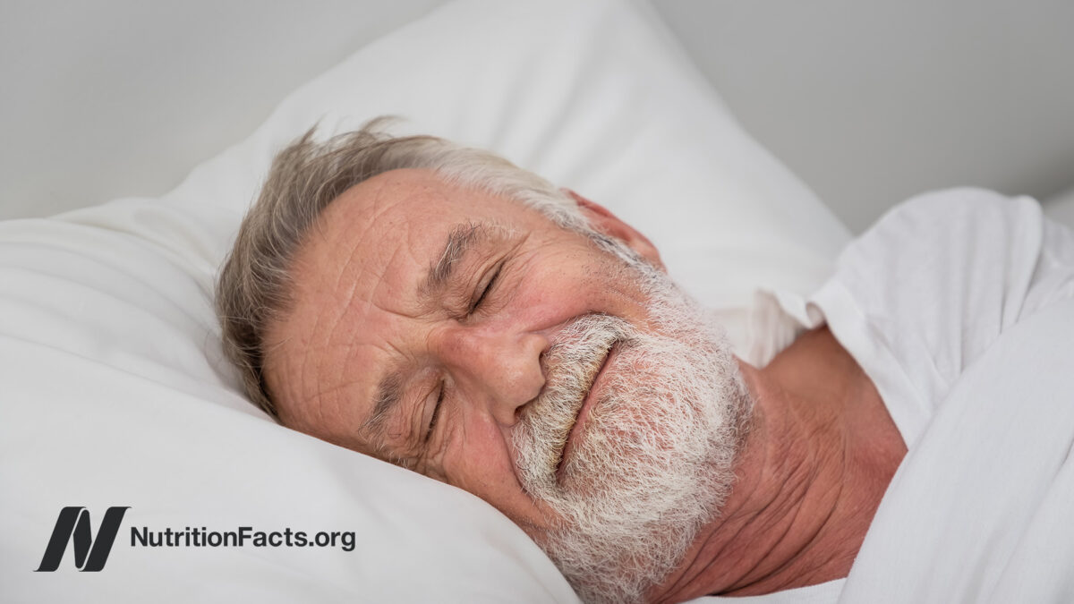 Older man sleeping soundly on white pillow