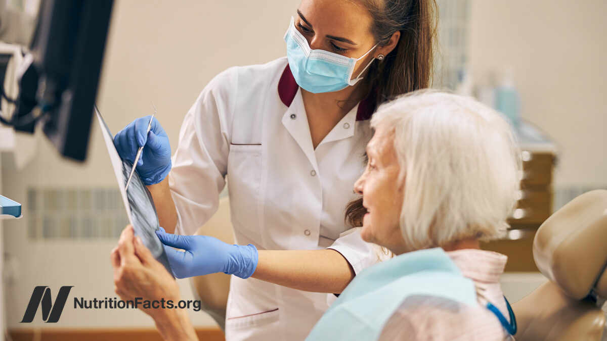 Dental assistant showing results to patient