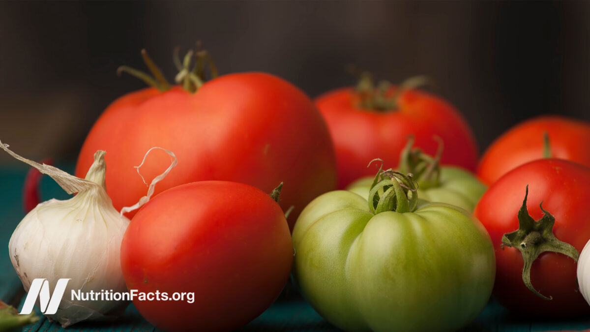 variety of tomatoes on black background