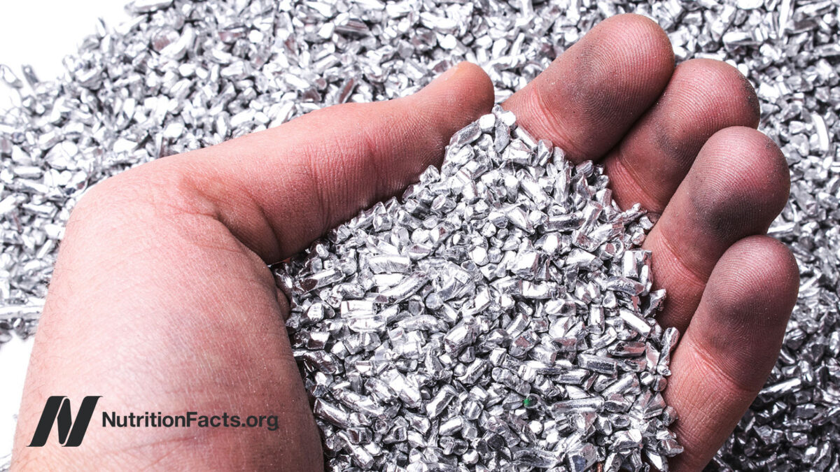 Hand scooping aluminum shavings from a pile