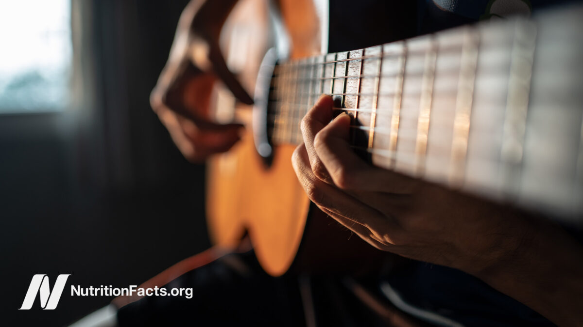 Close up of someone playing the guitar