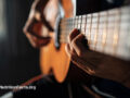 Close up of someone playing the guitar