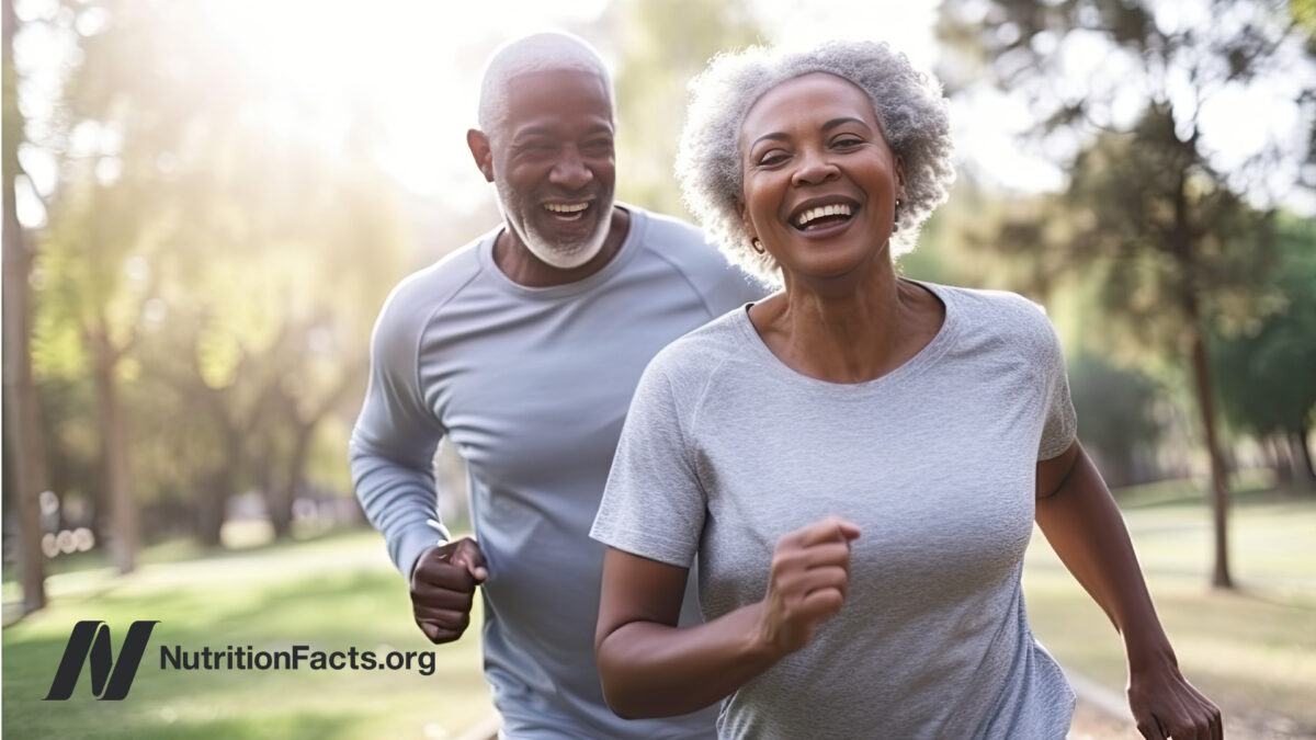 A mature couple running at the park