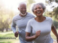 A mature couple running at the park