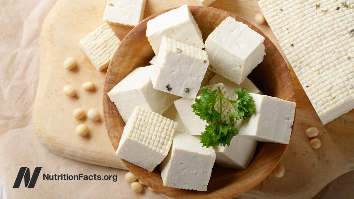 bowl of cubed tofu with a sprig of parsley on top