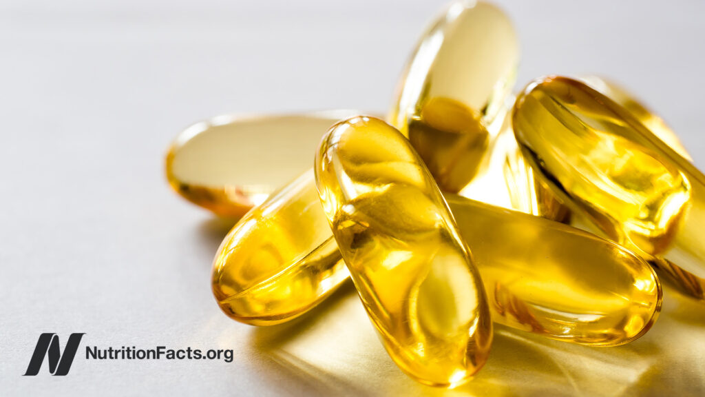 Fish oil capsules spilling out of a jar