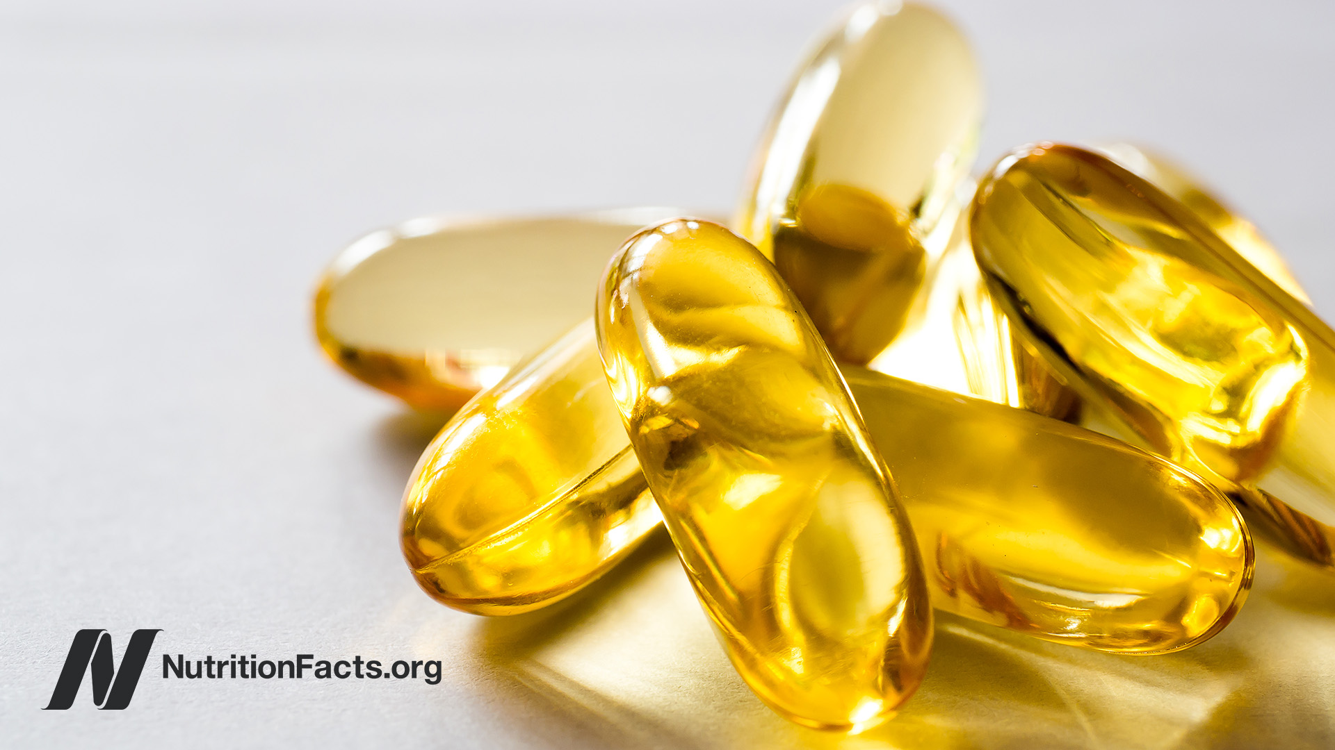 Fish oil capsules spilling out of a jar