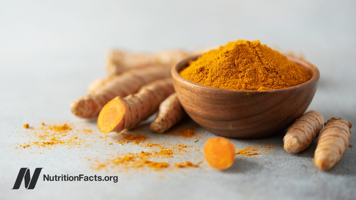 Powdered turmeric in a wooden bowl