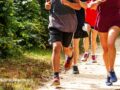 Running group coming towards camera on a trail