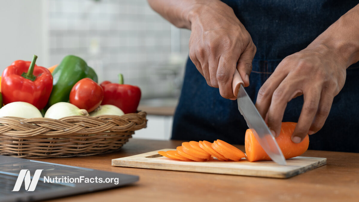 Man preparing vegetables on cutting board