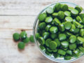 Chlorella tablets in a cup on a table