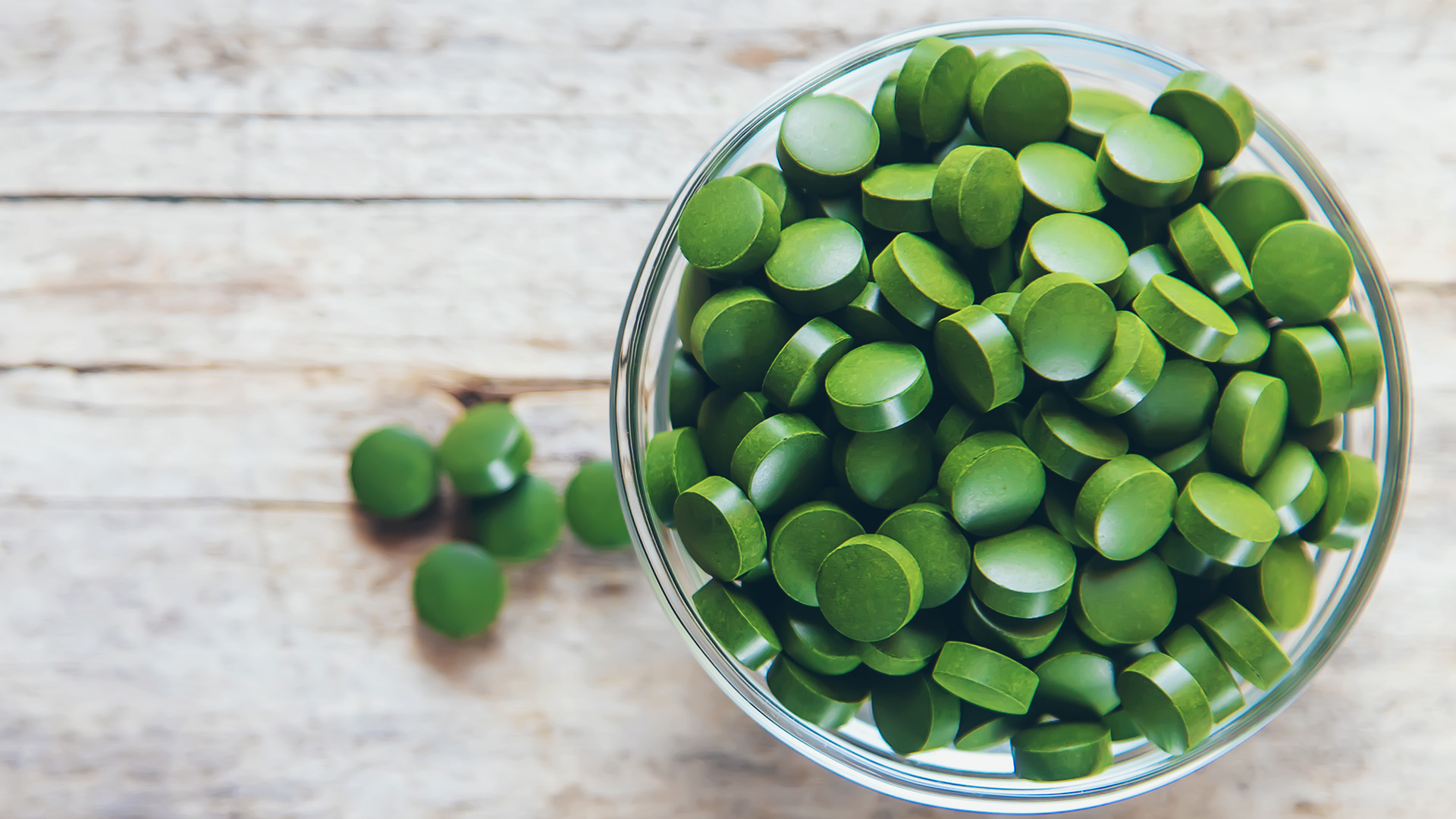 Chlorella tablets in a cup on a table