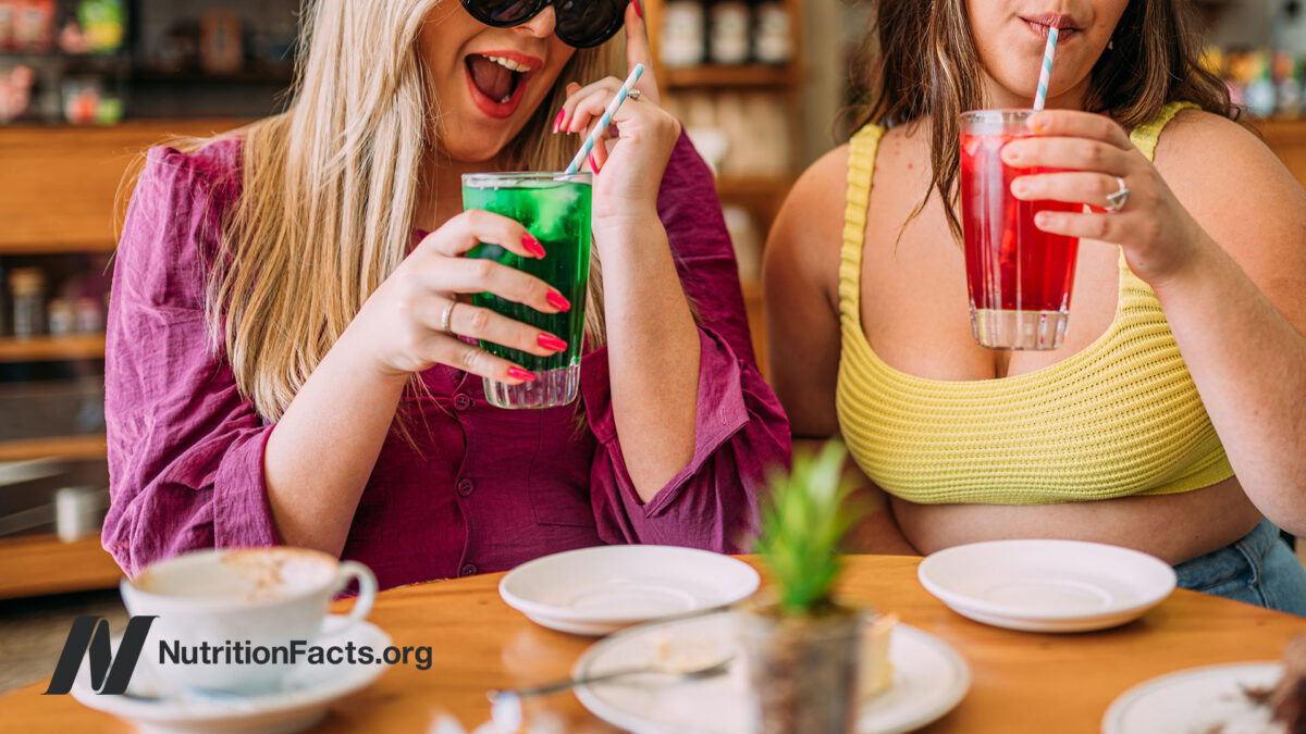 Two people enjoying colorful drinks