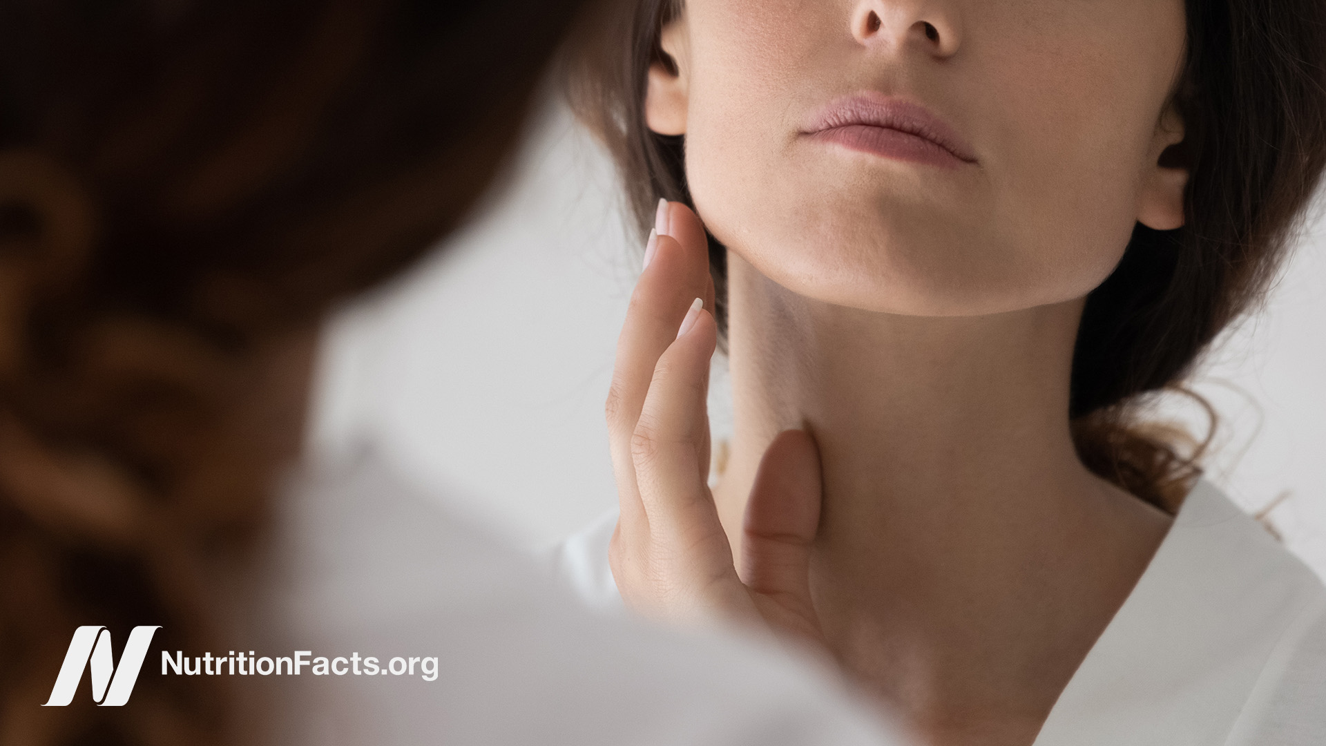 Woman looking at her face in the mirror