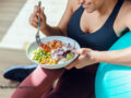 Person after a workout eating a big bowl of healthy foods