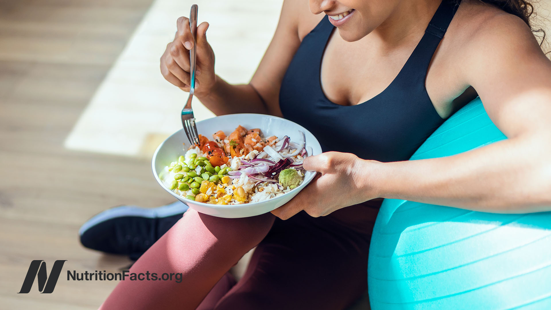 Person after a workout eating a big bowl of healthy foods