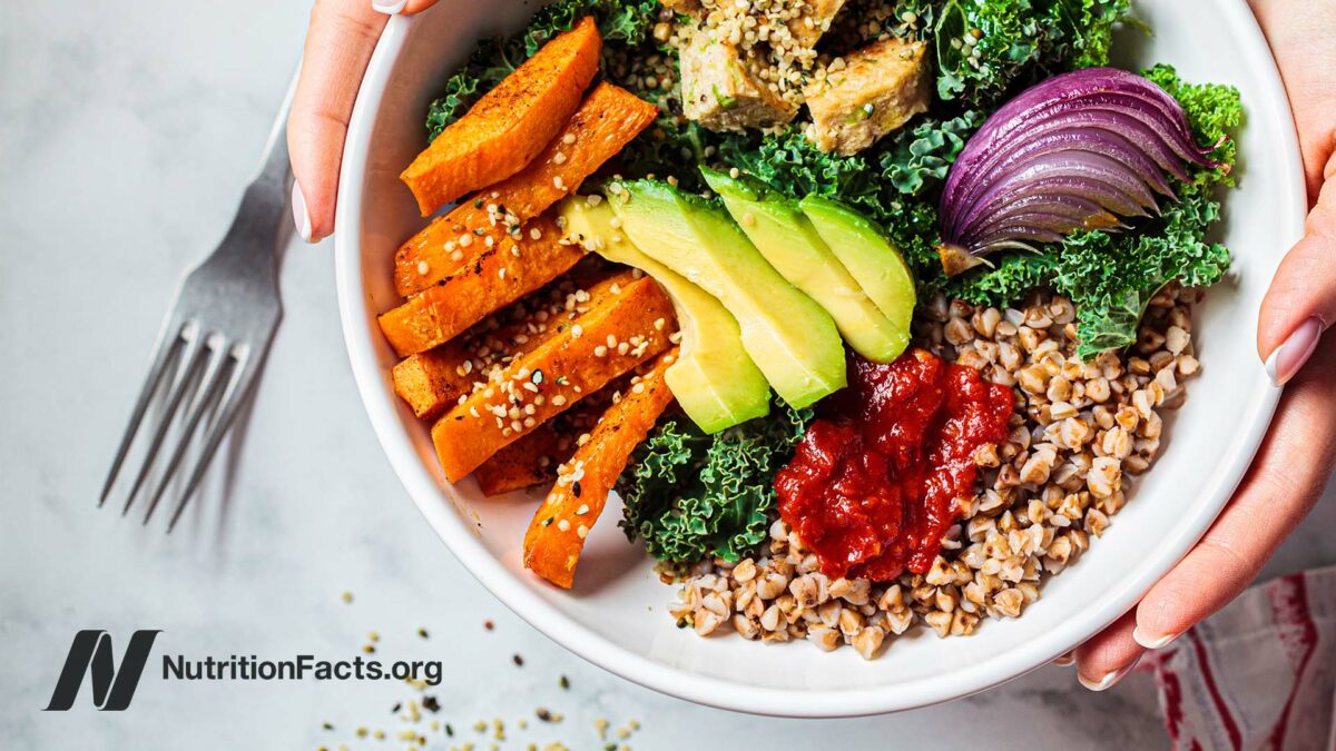 A bowl of healthy plant-based foods being presented