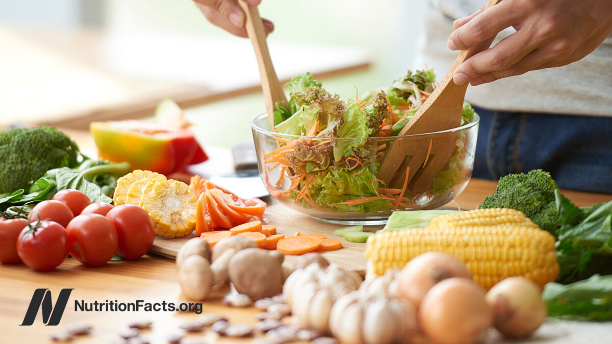 A person preparing a hearty salad