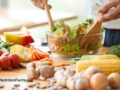 A person preparing a hearty salad