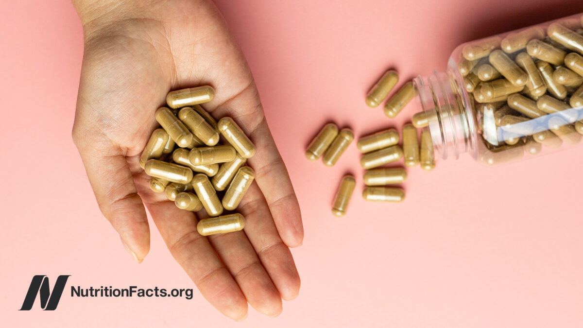 Powder capsules from a jar into the palm of a hand