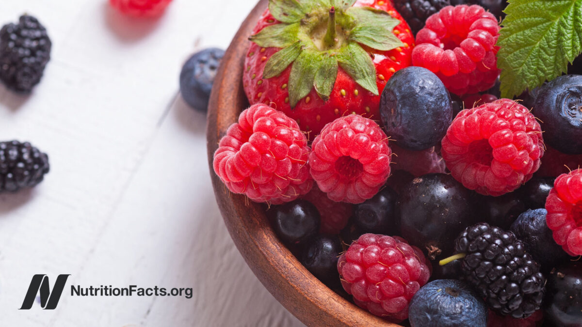Mixed fresh berries in a wooden bowl